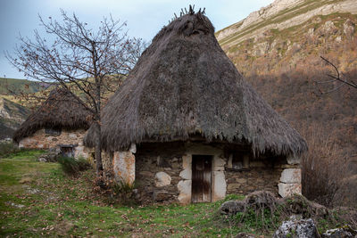 Old house on field against sky