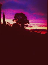 Silhouette of trees against dramatic sky