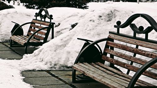 Snow on railing against sky during winter