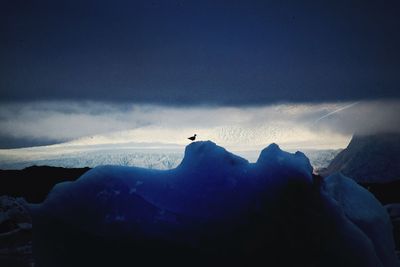 Scenic view of mountains against cloudy sky