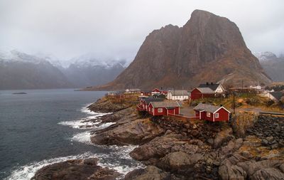 Scenic view of sea and mountains against sky