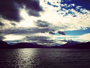 Scenic view of lake against cloudy sky