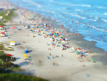 Tilt-shift image of people on beach