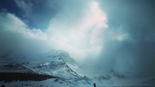 Scenic view of snow covered mountains against sky