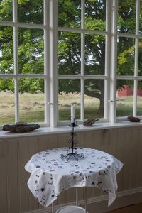 Table and trees seen through glass window at home
