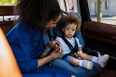 Mother with son sitting in car