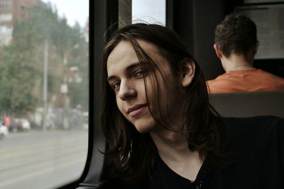 Portrait of smiling man sitting in bus