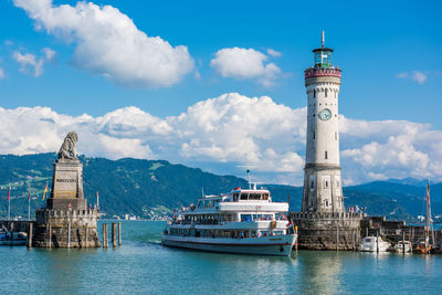 View of lighthouse by sea against sky