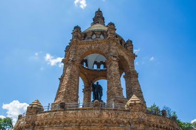 Low angle view of historical building against blue sky