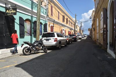 Cars on street amidst buildings in city