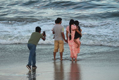 Rear view of people on beach