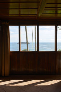 Scenic views of the sea from inside the wooden bedroom through the windows