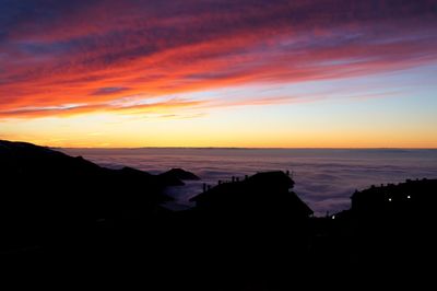 Scenic view of sea against romantic sky at sunset