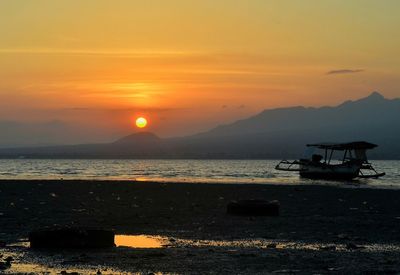 Scenic view of sea against orange sky