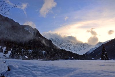 Scenic view of snow covered mountains against sky