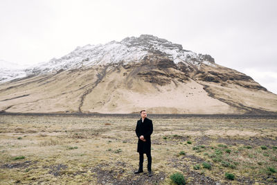 Full length of man standing on mountain