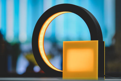 Close-up of yellow electric lamp on table