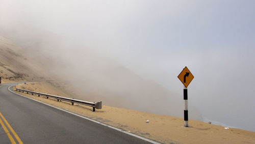 Panoramic view of mountain road in foggy weather