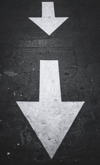 High angle view of arrow symbol on road