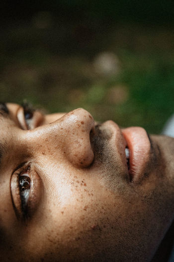 Close-up of thoughtful young man looking away outdoors