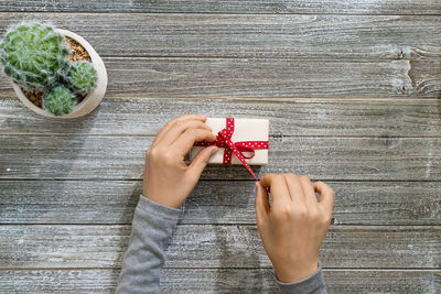 High angle view of woman hand on table