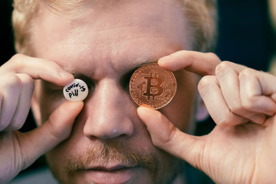 Close-up of hand holding bitcoin