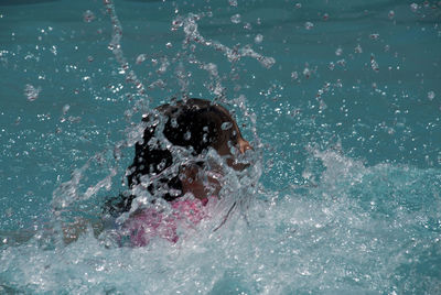 Woman jumping in water