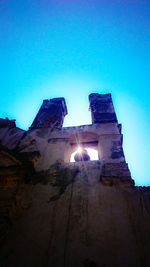 Low angle view of ruins against clear blue sky