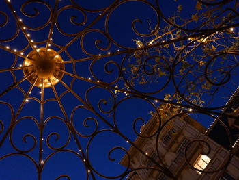 Low angle view of illuminated building against sky