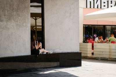 People sitting outside building