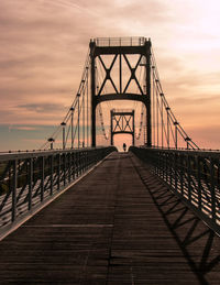 View of suspension bridge against cloudy sky