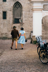 Rear view of couple walking on street