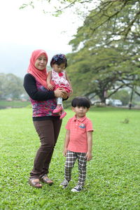 Full length of women standing on grass