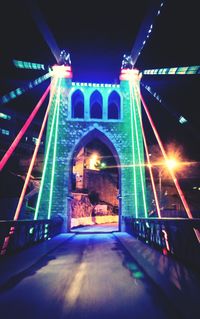 Illuminated tunnel at night