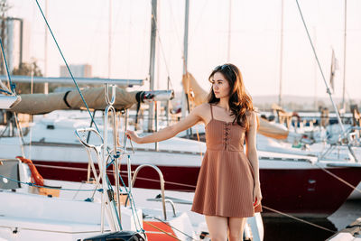 Portrait of beautiful woman standing in boat