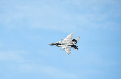 Low angle view of airplane flying in sky