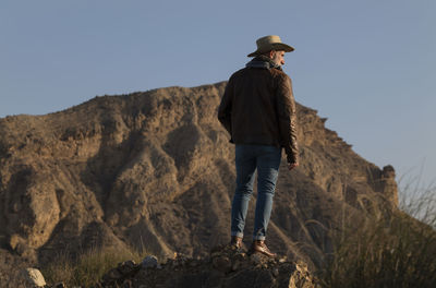 Adult man in cowboy hat in tabernas desert, almeria, spain