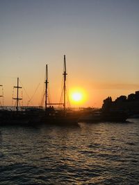 Silhouette sailboats on sea against sky during sunset