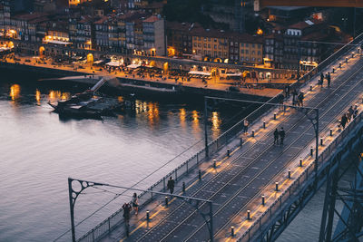 Aerial view of illuminated bridge over river at night