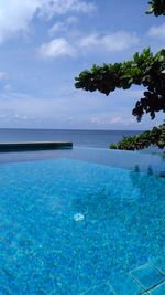 Scenic view of swimming pool by sea against sky