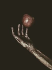 Close-up of human hand against black background