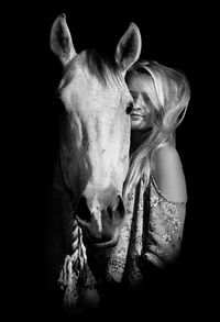 Close-up of horse against black background