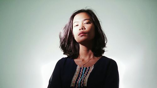 Woman looking at camera over white background