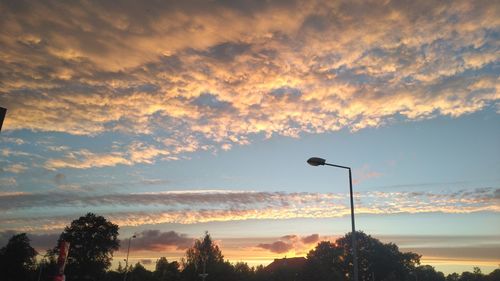 Low angle view of silhouette street against sky during sunset