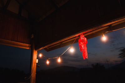 Low angle view of illuminated lights against sky at night