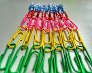 Close-up of colorful paper clips on table