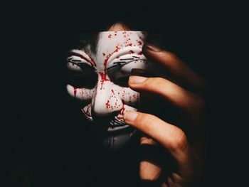 Woman holding hands over black background