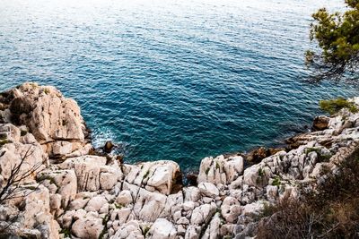 High angle view of rocks by sea
