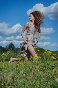 Woman running on field against sky