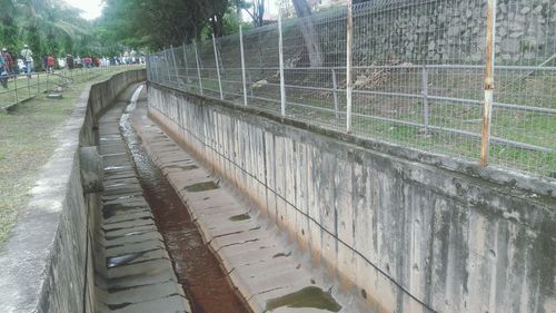 Footpath by fence in city